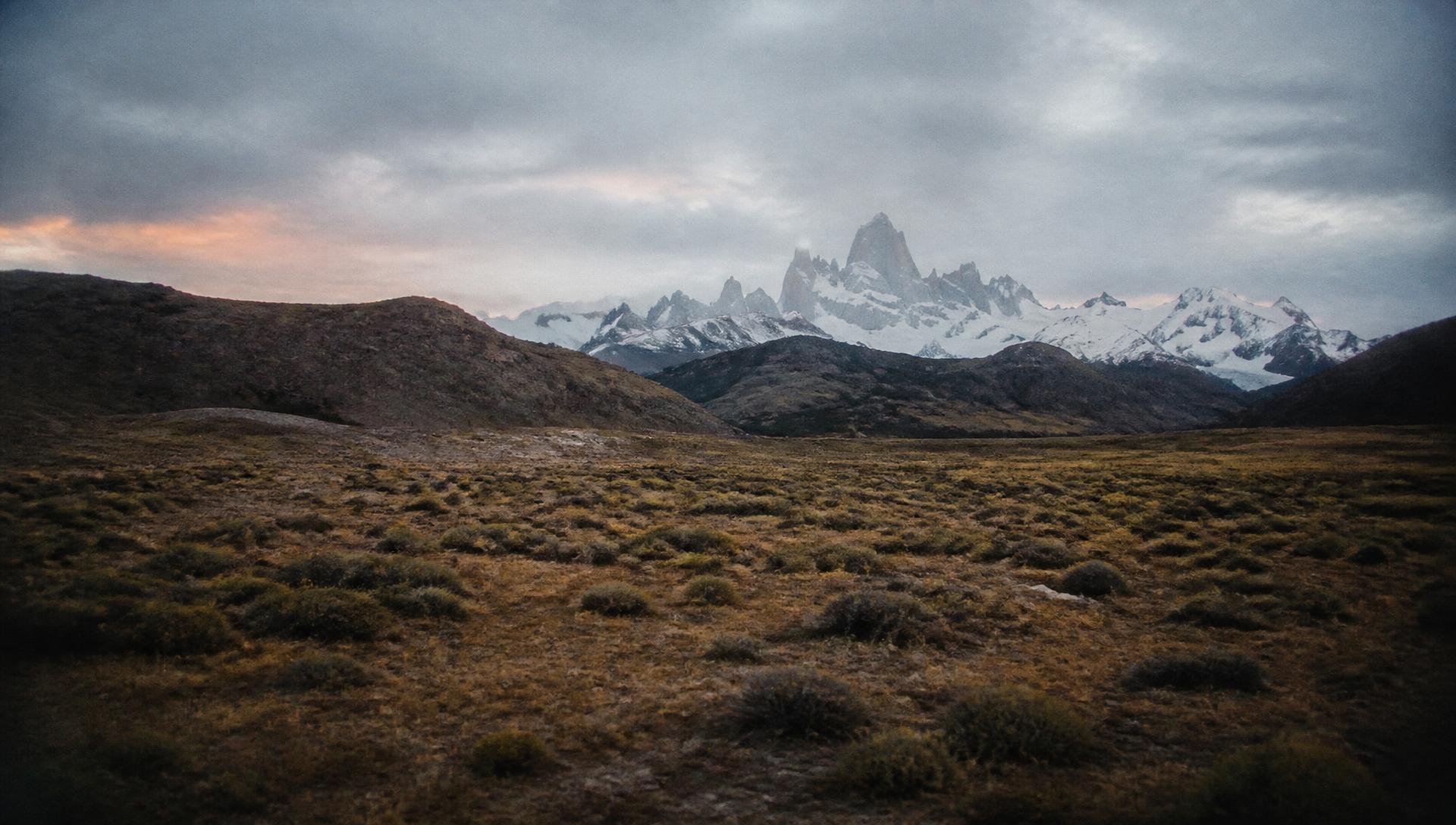 Golden hour over a turquoise glacial lake and jagged peaks in Patagonia, Argentina